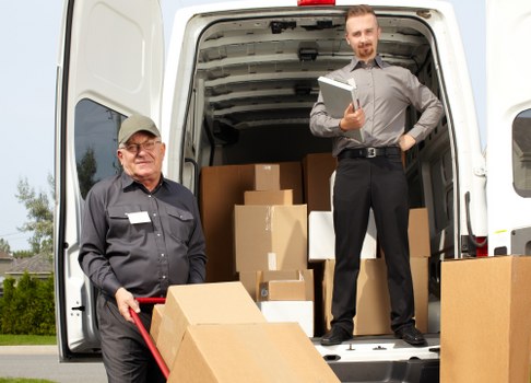 Moving team loading household items for a UK removal service